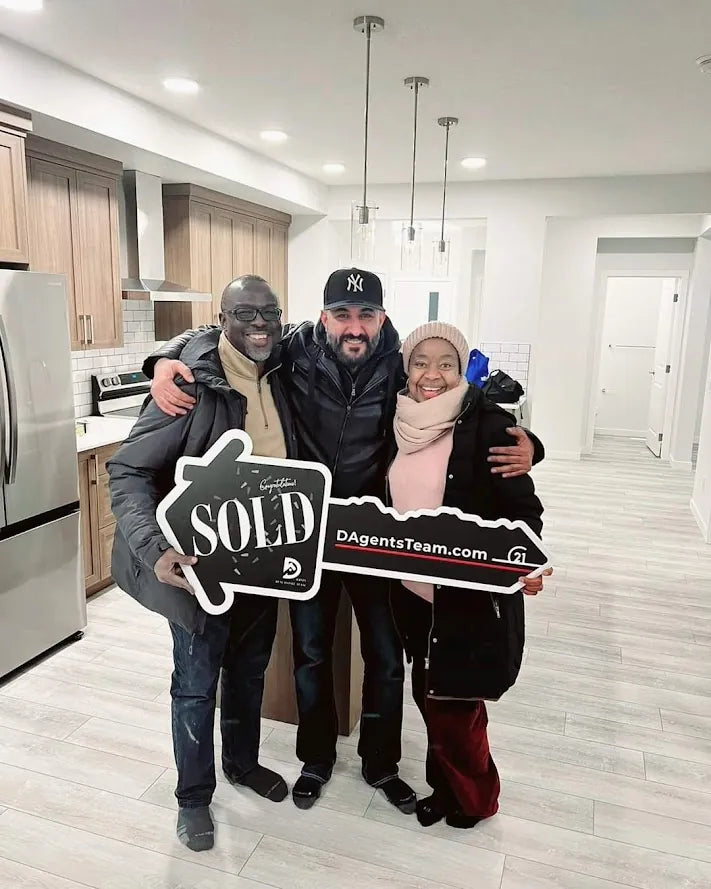 Clients holding a sold sign with Jasjeet Singh