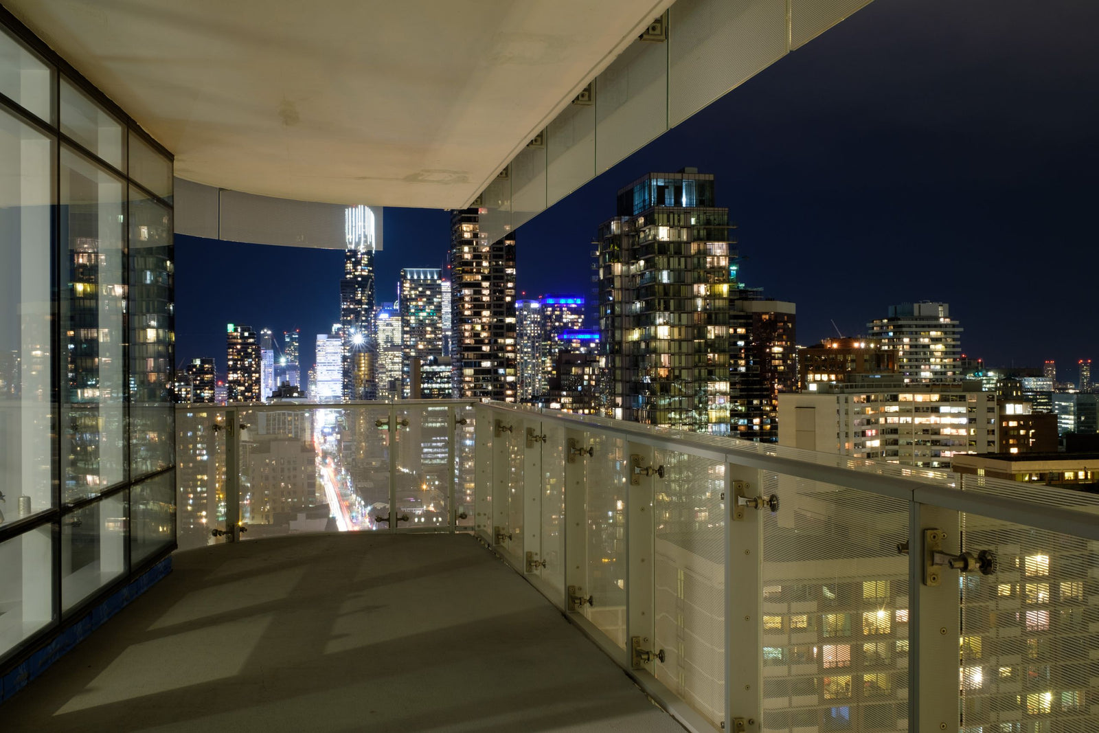 Condominium balcony overlooking the city at night