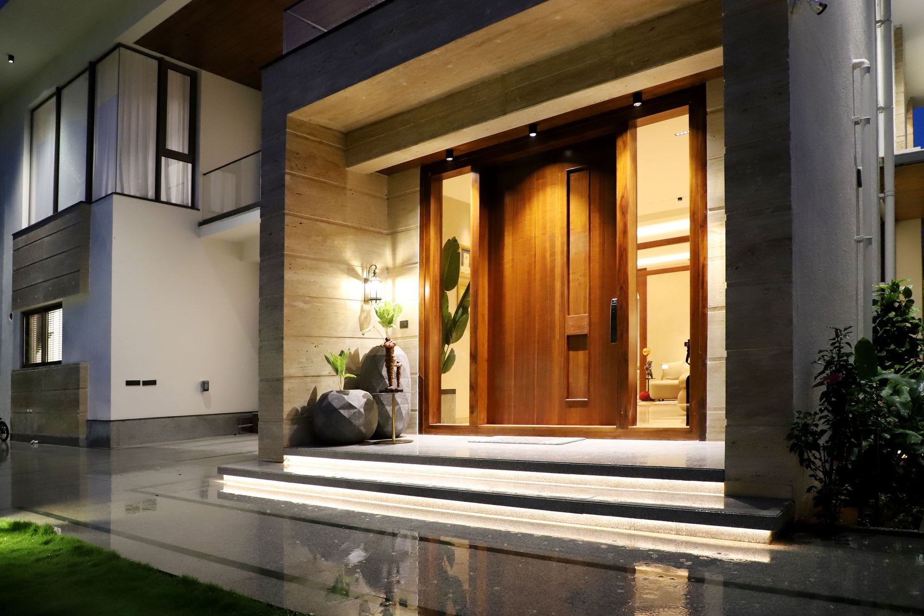 Luxury home entrance illuminated at dusk